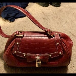 Red handbag with accent lock and key.